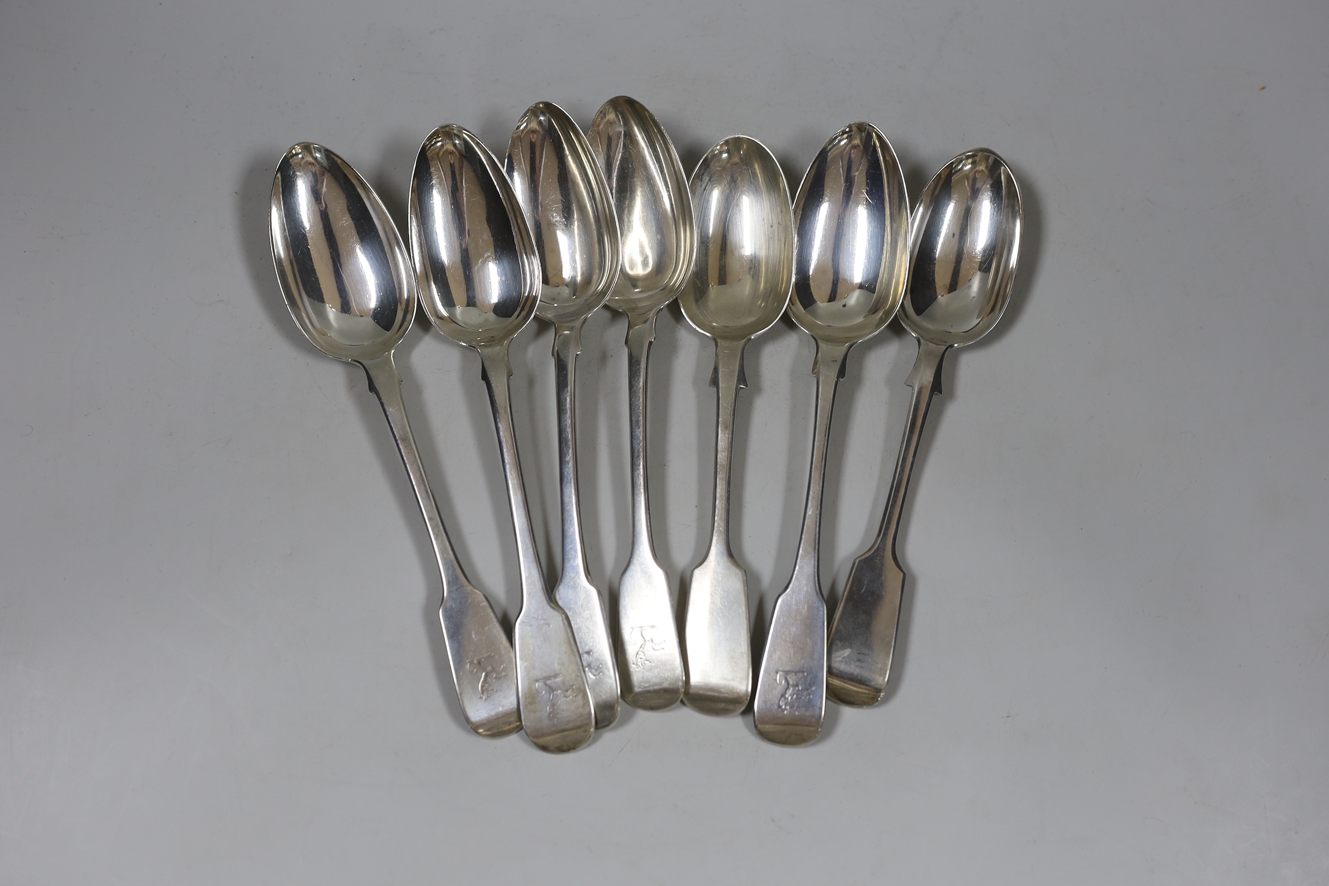 A harlequin set of seven George III and later silver fiddle pattern table spoons, various dates and makers, 16.1oz.